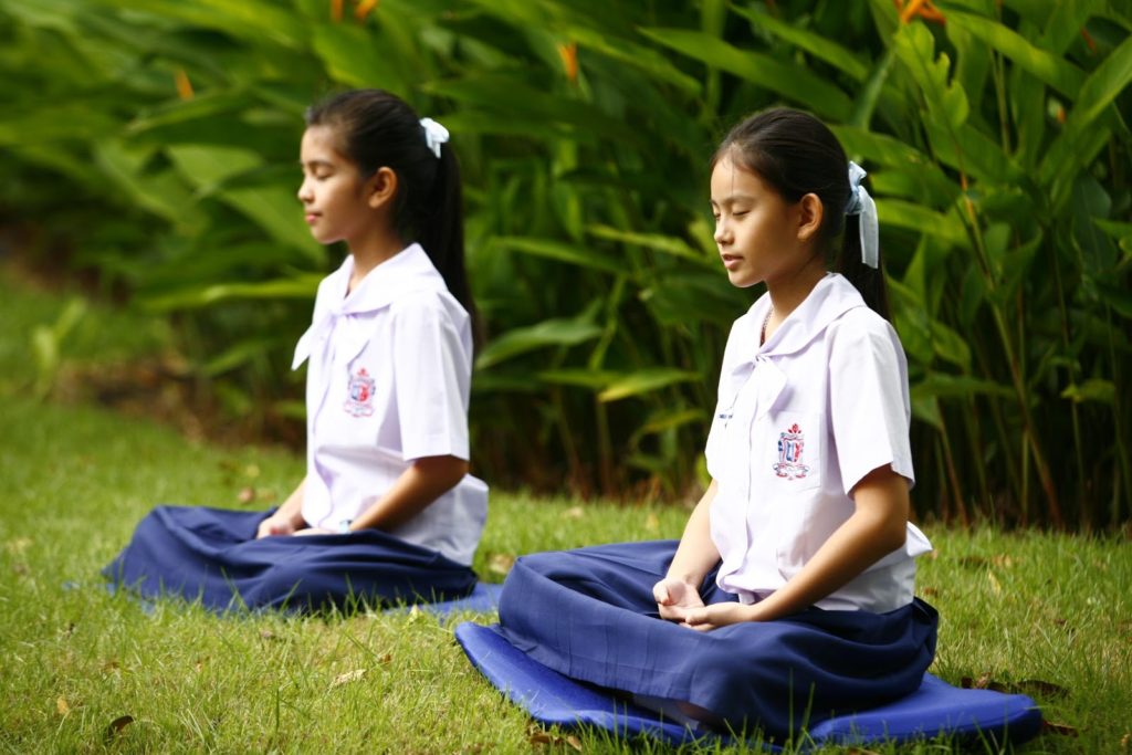 Two Children Practicing Mindfulness on The Grass