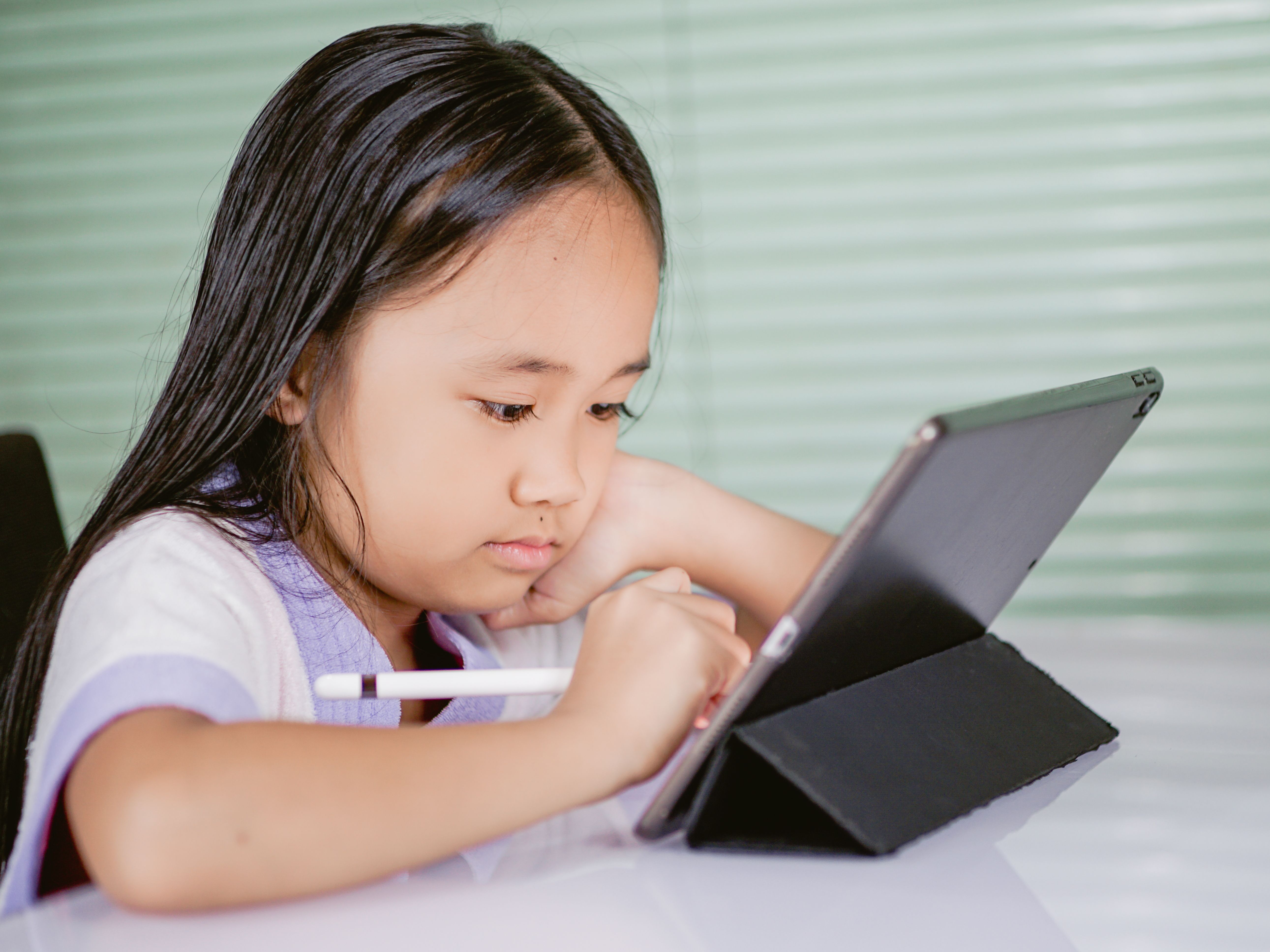 Young student using a tablet to take an interactive online quiz